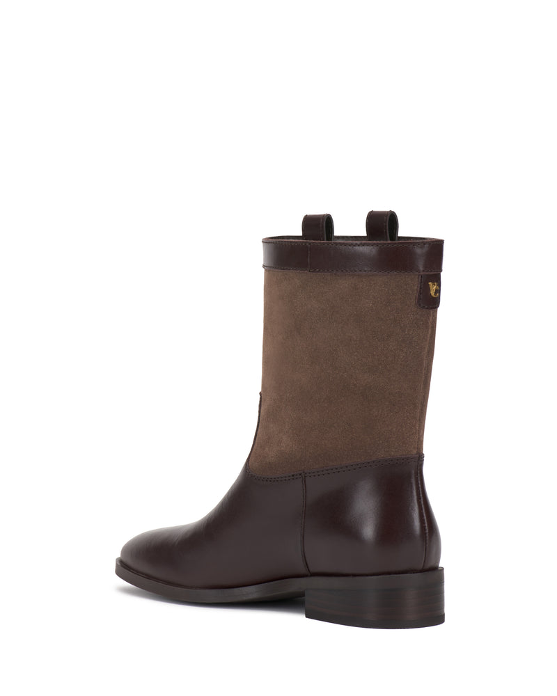 Introducing the Bezzley Bootie by Vince Camuto—a brown leather and suede mid-calf boot designed with two pull tabs, a rounded toe, low block heel, and a subtle logo detail near the top. Photographed against a white background.