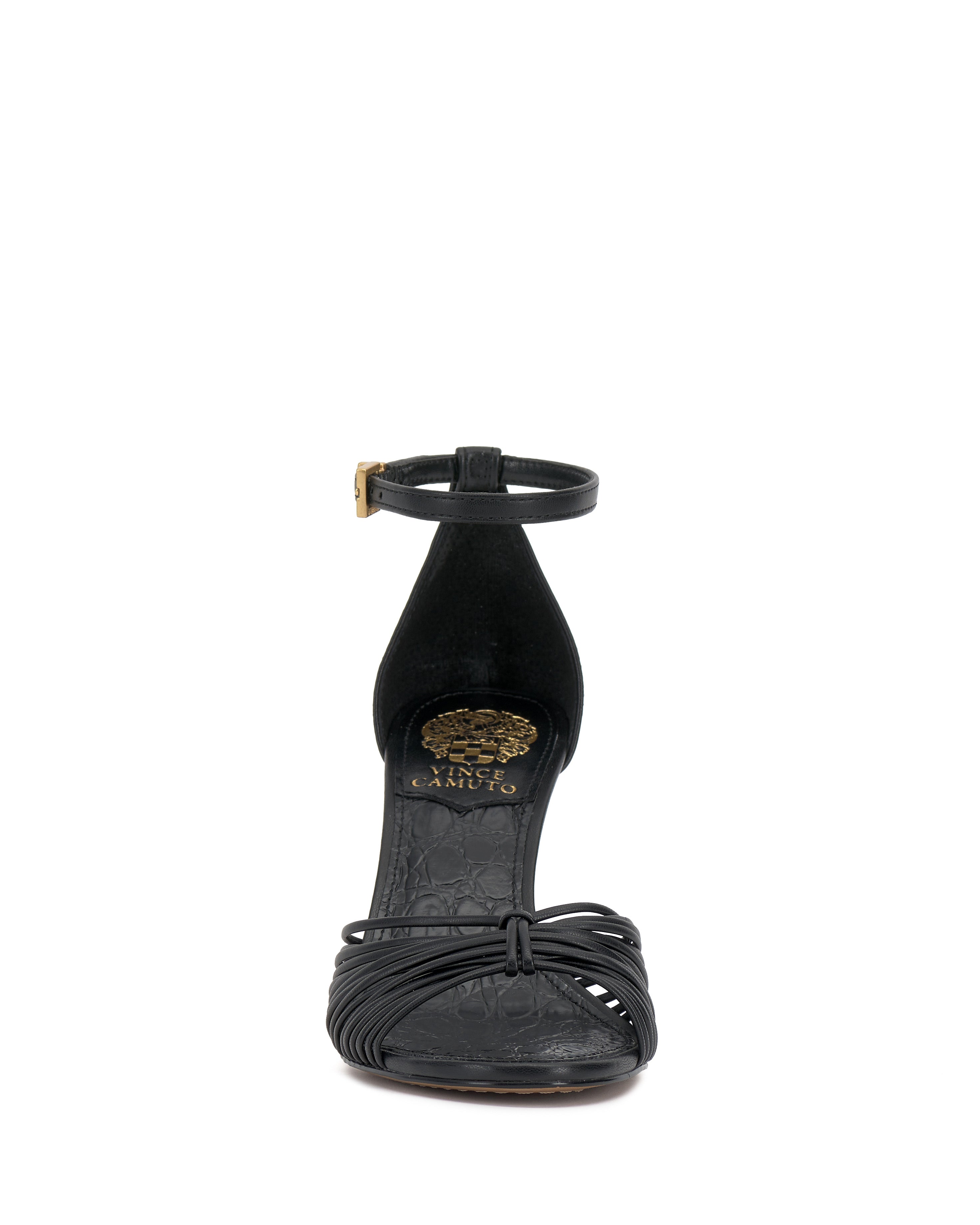 Front view of the Vince Camuto Blaine Sandal: a black strappy open-toe high heel with ankle strap and gold buckle; gold emblem and floral design on the insole.