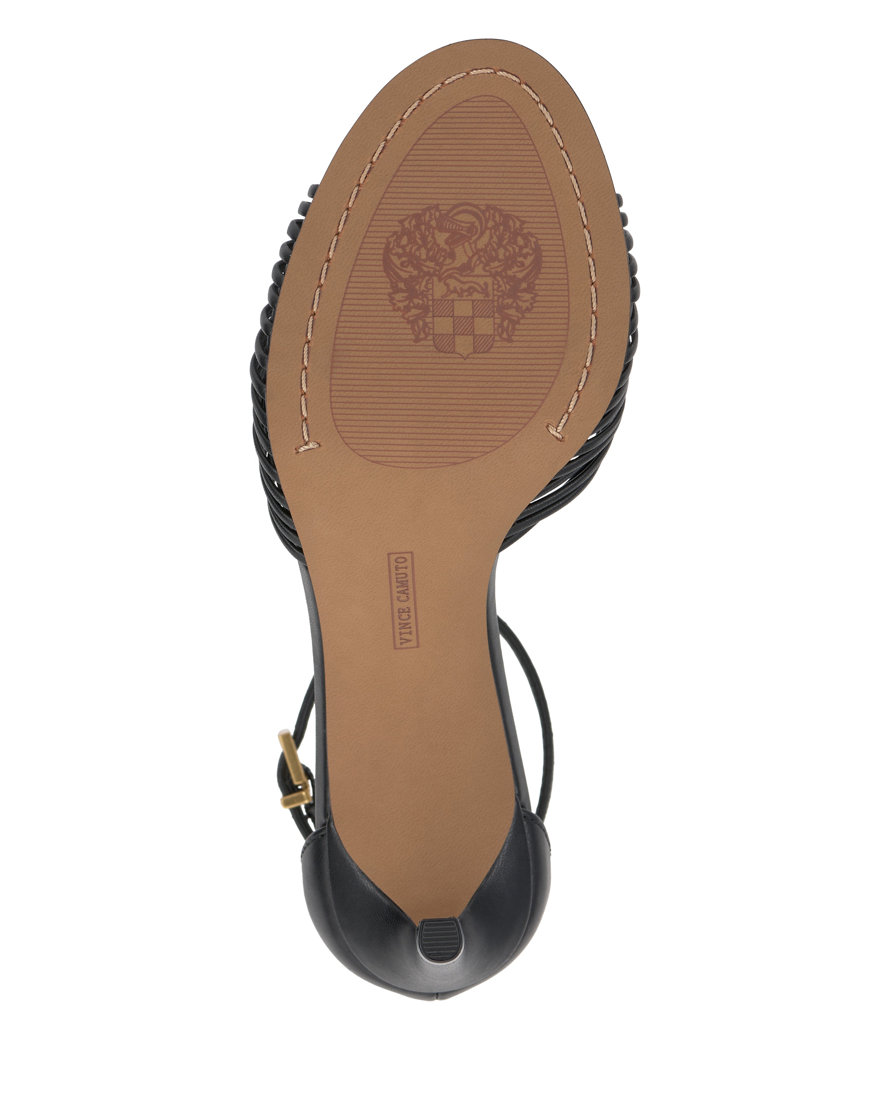 The image shows the bottom view of the Vince Camuto Blaine Sandal, a women's black sandal with a tan stitched sole, ankle strap, crest-shaped emblem at the center, and a "MADE IN INDIA" stamp near the heel.