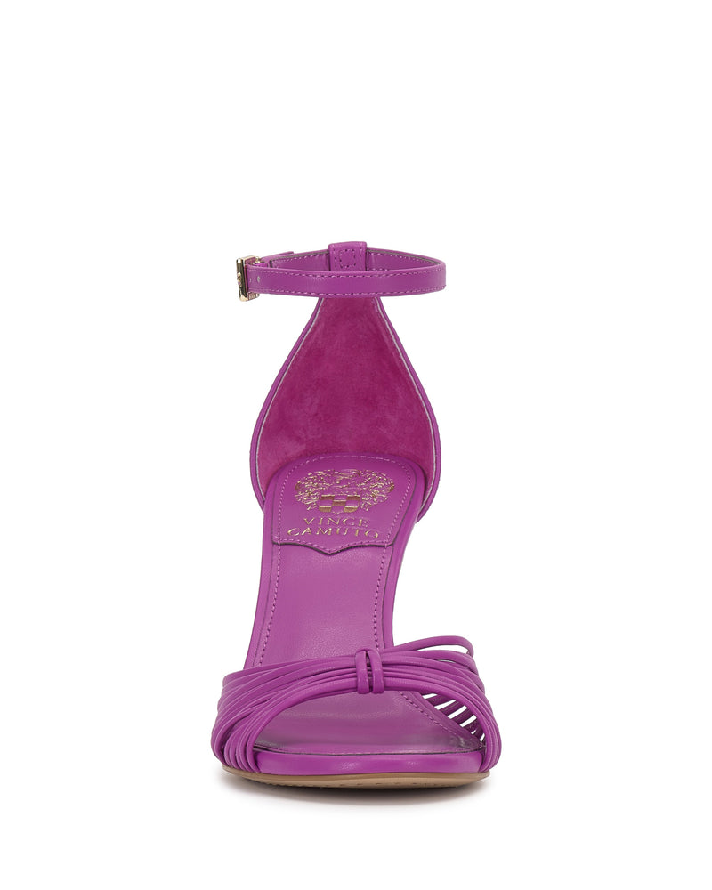 Front view of the Blaine Sandal by Vince Camuto in bright purple, featuring a tall heel, skinny ankle strap with gold buckle, crisscrossed toe straps, gold-embossed insole logo, and subtly reptile-embossed upper.