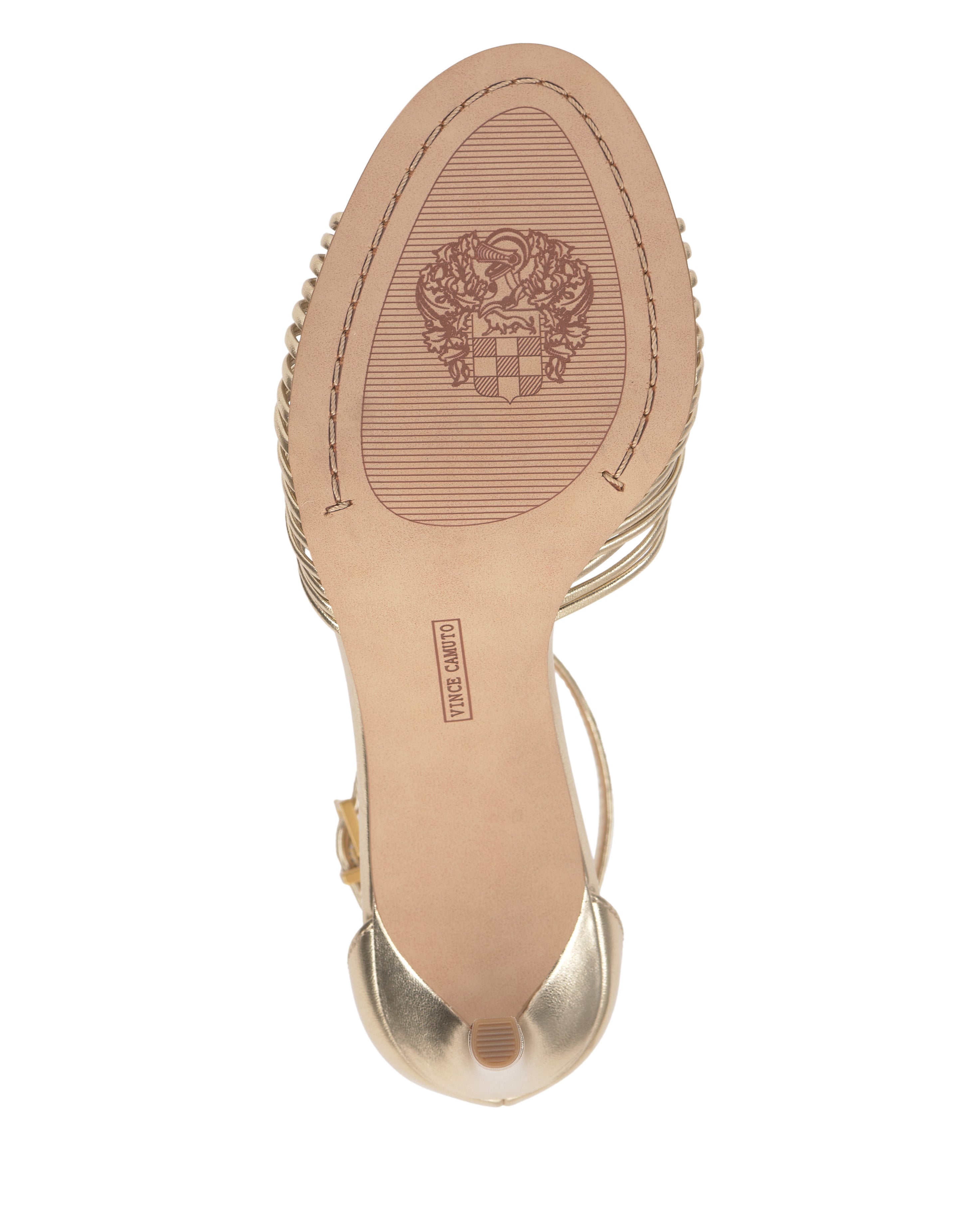 The image shows the sole of the Blaine Sandal by Vince Camuto, a gold strappy open toe high-heeled shoe featuring a decorative emblem and "Made in Japan" engraved on the bottom.