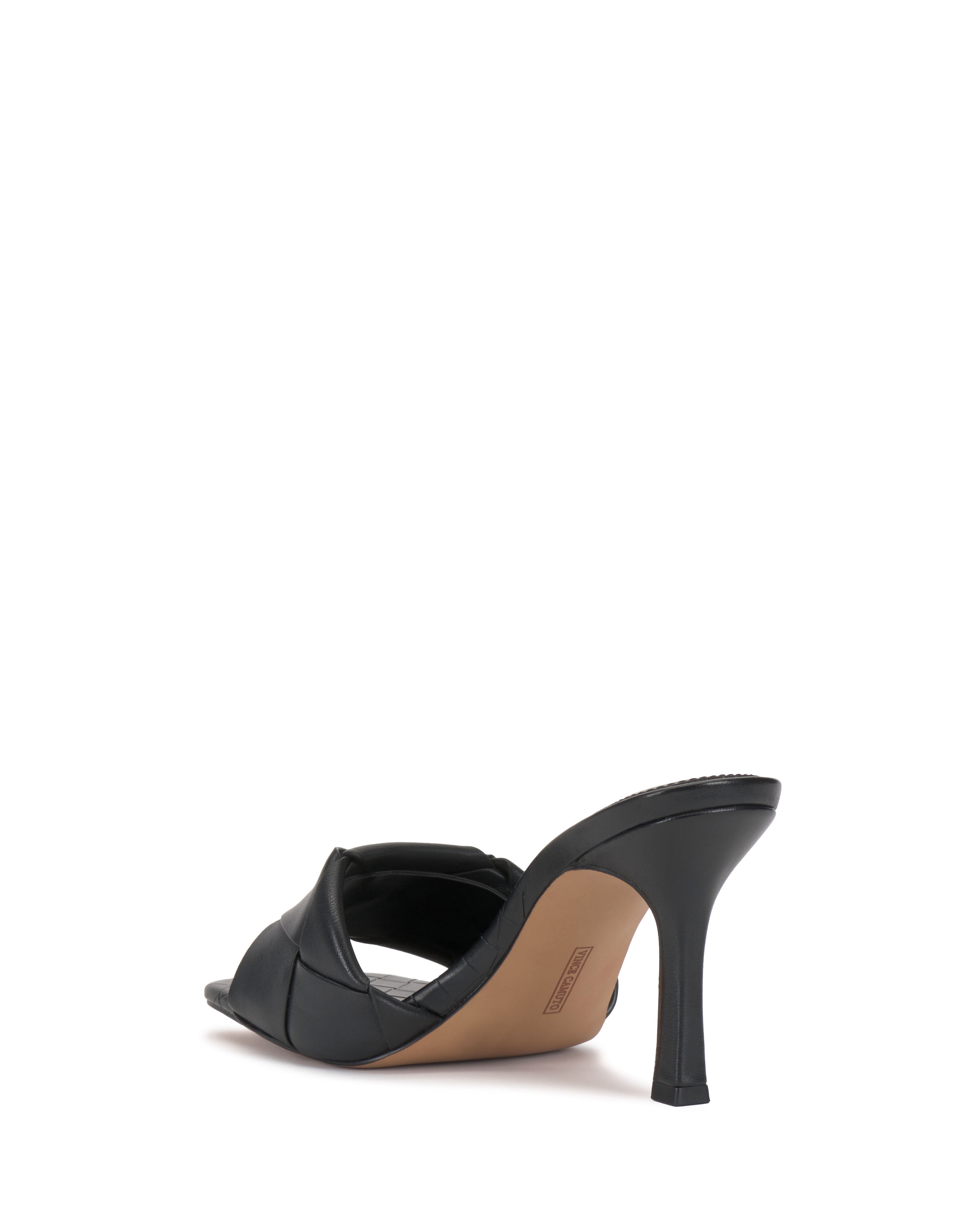 The Vince Camuto Brelanie Woven Mule is a black open-toe sandal with a woven strap and a slim, slightly flared heel, shown from the back on a white background.
