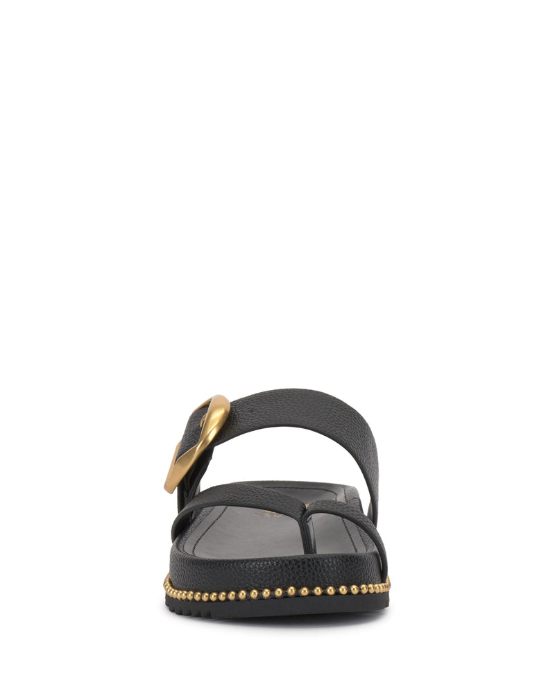 The Vince Camuto Camilo Slide is a black sandal with a wide strap, large gold buckle, and gold studs around the sole. Its contoured footbed ensures comfort while adding style.
