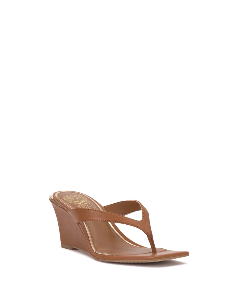A single Cianna Wedge Sandal by Vince Camuto, featuring a brown thong design with a wedge heel and open toe, is shown angled against a plain white background.