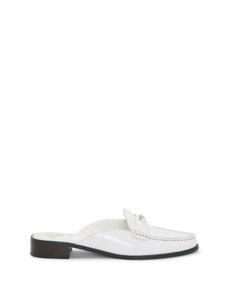Introducing the Cobby Mule from Vince Camuto—a chic white patent leather loafer featuring a moc toe with detailed stitching, a decorative metal accent on the upper front, and a stylish brown low block heel.