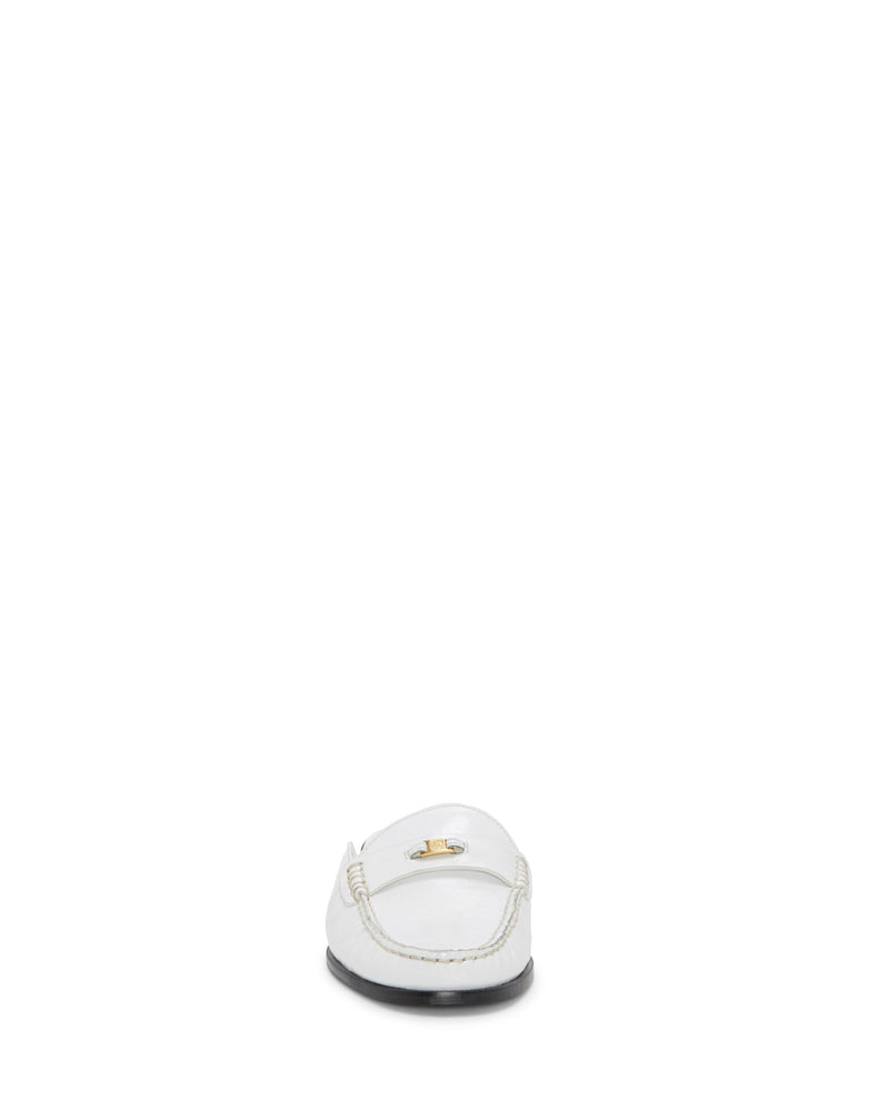 The Vince Camuto Cobby Mule is shown from the front against a plain white background, highlighting its classic silhouette in white with visible stitching details and a gold emblem on the upper.