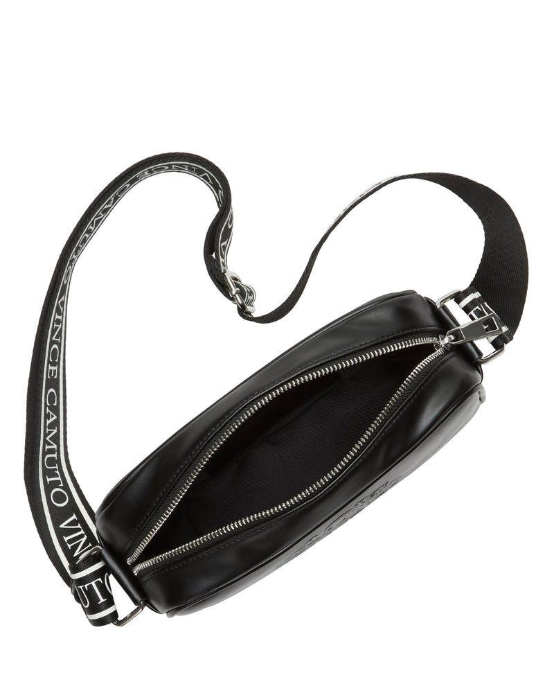 A black Dalle Crossbody Bag by Vince Camuto featuring a zippered opening and an adjustable logo webbing strap with "VINCE CAMUTO" in white text. The empty bag is displayed from a top angle.