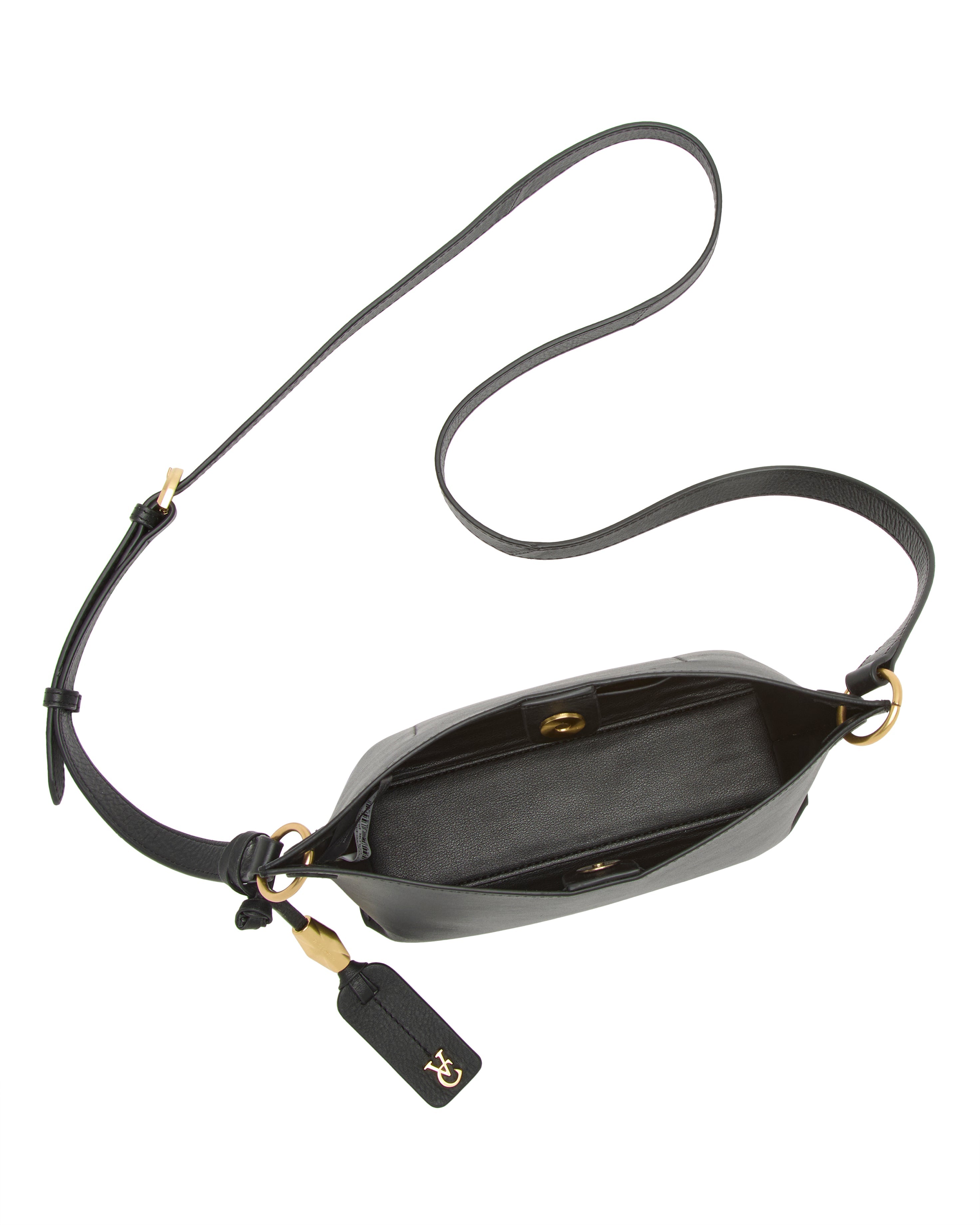 The Vince Camuto Ellah Crossbody Bag features black leather, a long adjustable strap, gold hardware, and an open top with a spacious interior. A leather tag with gold initials hangs from one of the strap rings.
