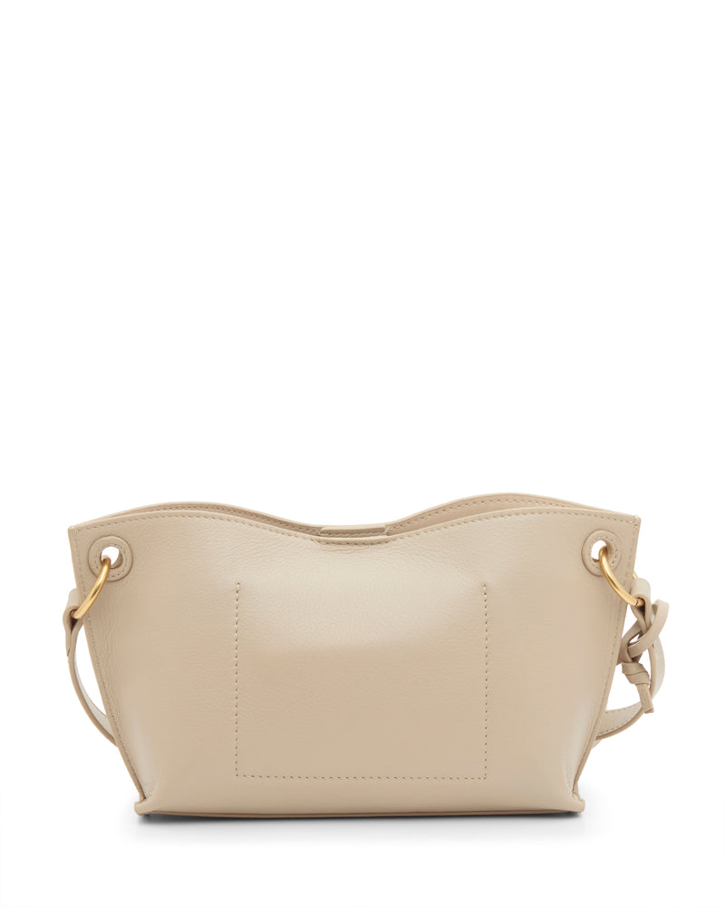 The Ellah Crossbody Bag by Vince Camuto is a small beige leather handbag with gold-tone grommets, adjustable side ties, a wavy top edge, and stitched rectangular front detail.