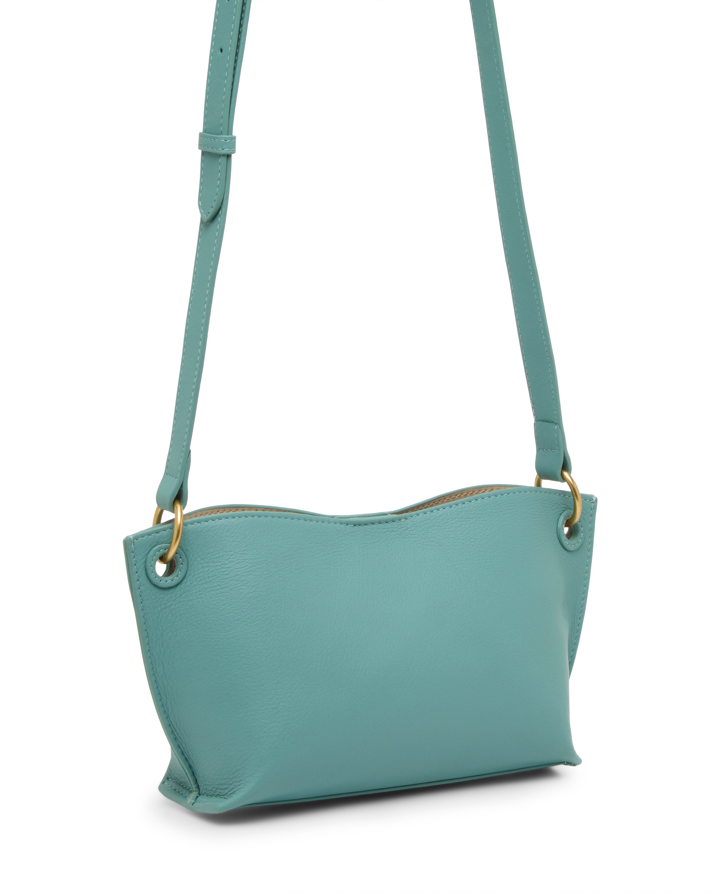 The Vince Camuto Ellah Crossbody Bag is a small, light teal leather bag with gold hardware, an adjustable strap, and a minimalist design shown against a white background.