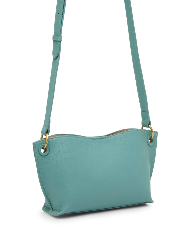 The Vince Camuto Ellah Crossbody Bag is a small, light teal leather bag with gold hardware, an adjustable strap, and a minimalist design shown against a white background.