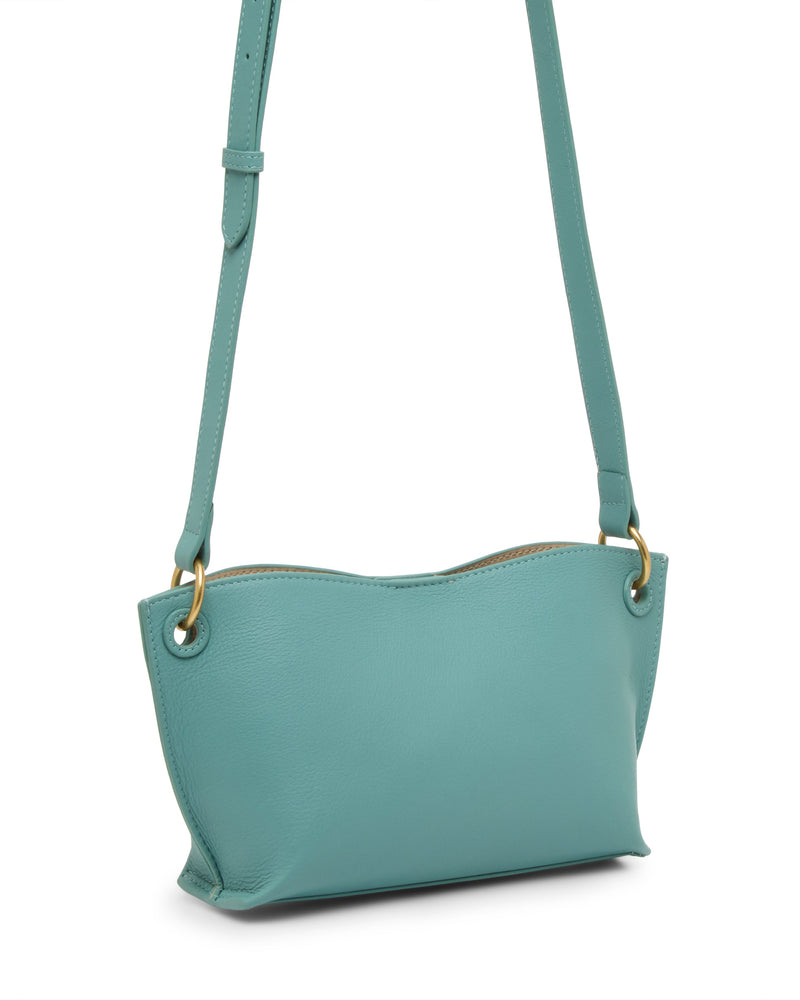 The Vince Camuto Ellah Crossbody Bag is a compact teal leather bag with gold hardware and an adjustable strap, displayed on a white background.