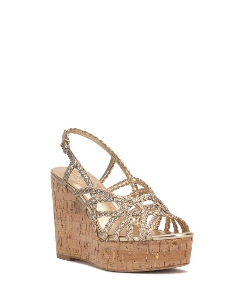 The Vince Camuto Elody Wedge Sandal showcases a cork heel, multiple braided gold straps, an ankle strap, and an open toe in a chic wedge silhouette.