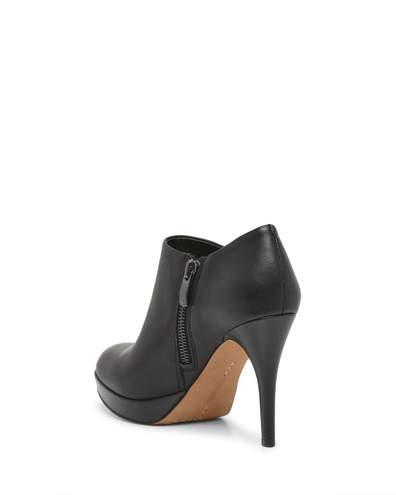The Vince Camuto Elvin Bootie is a black high-heeled ankle bootie featuring a side zipper and a tan platform sole, shown from the back and slightly angled against a white background.