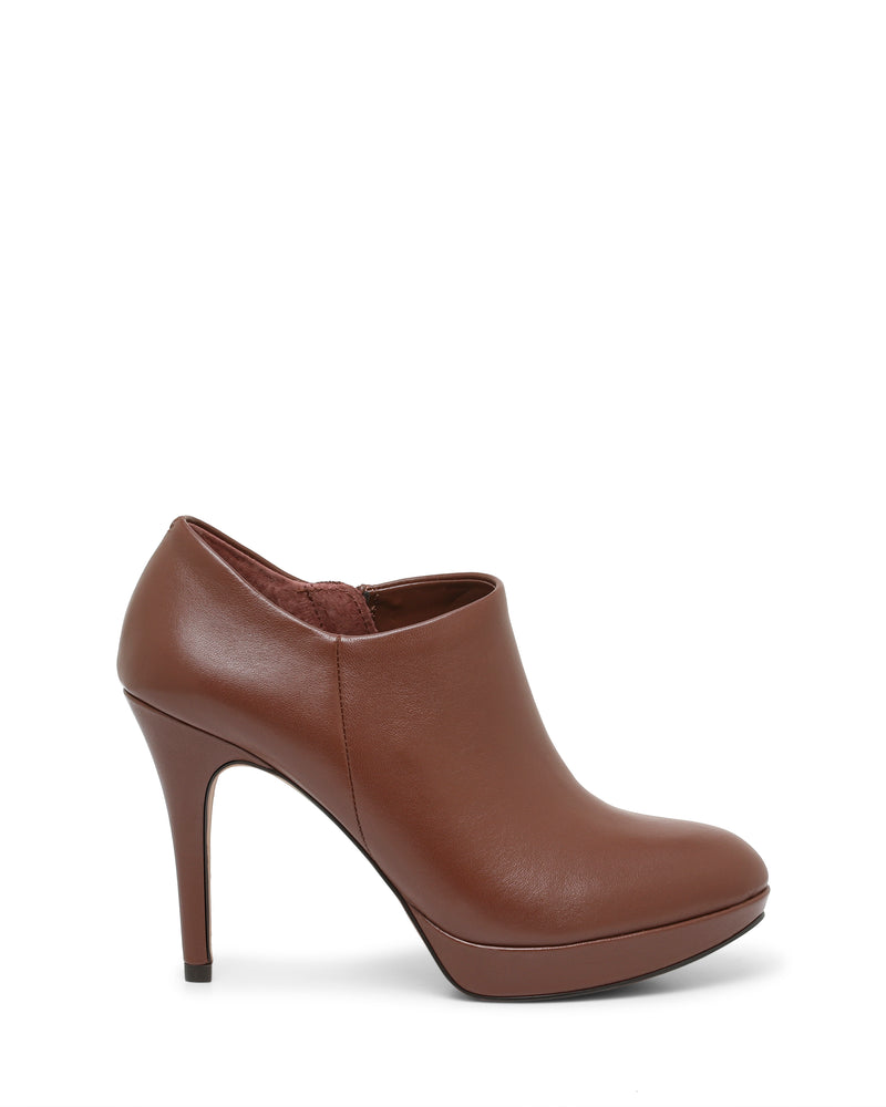 The Elvin Bootie by Vince Camuto is a brown leather ankle bootie featuring a closed toe, side zipper, and sky-high heel, displayed on a white background.