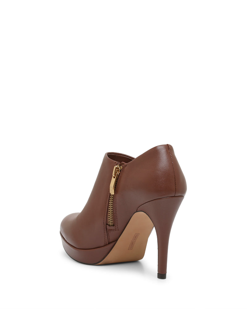 The Elvin Bootie by Vince Camuto, featuring a sky-high heel, platform sole, and side zipper, is shown from a rear angle against a white background.