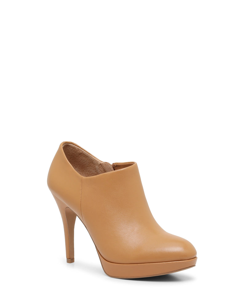 The Elvin Bootie by Vince Camuto is a tan, high-heeled platform ankle bootie crafted from smooth leather, featuring a sky-high heel and platform sole, displayed at a slight angle on a white background.