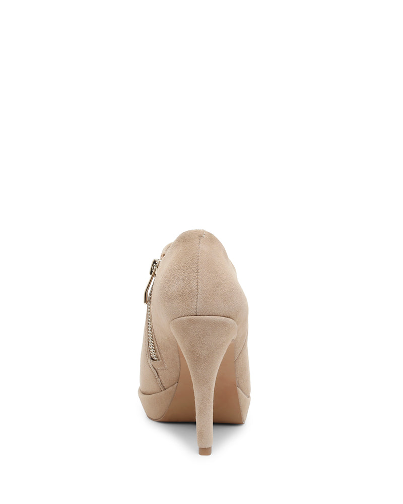 The Elvin Bootie by Vince Camuto is photographed from the back, highlighting its beige suede finish, pointed high heel, and side zipper detail.