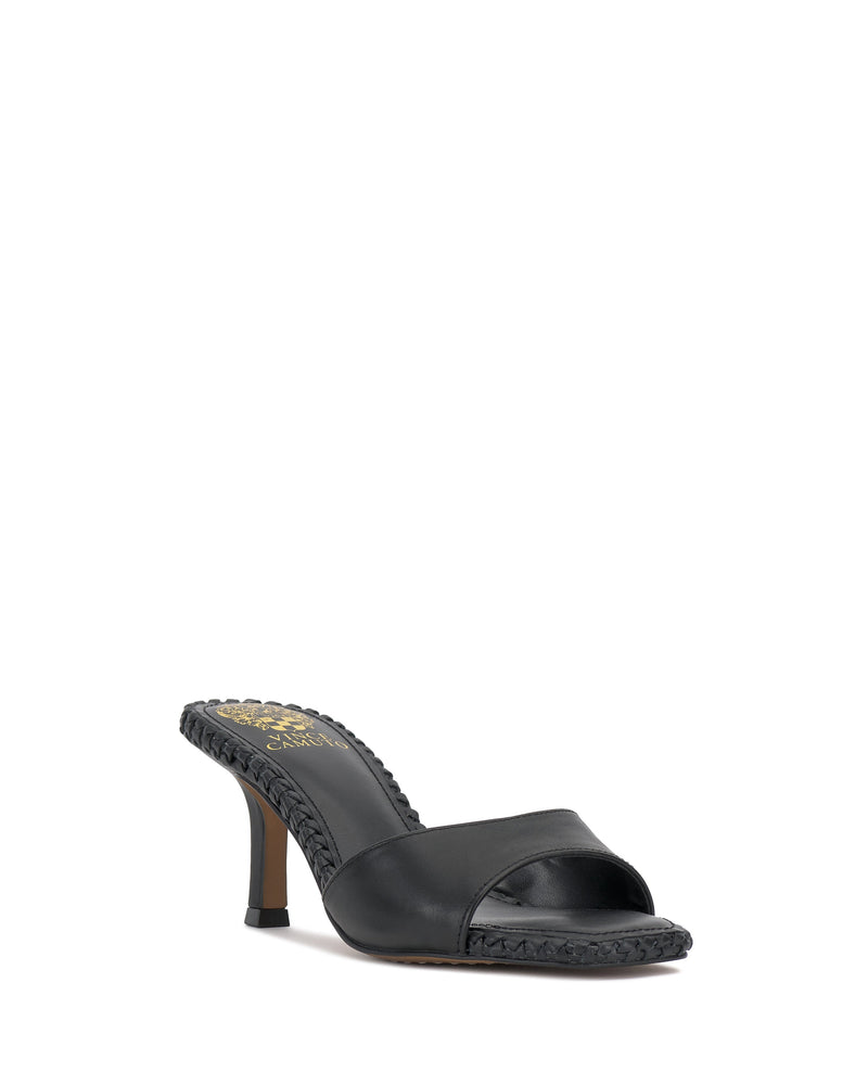The Emmla Mule by Vince Camuto is a black, open-toe, slip-on sandal featuring mid-height stiletto heels and braided edging—perfect for adding modern elegance to any women’s outfit.