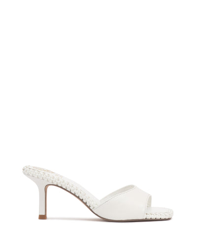 The Emmla Mule by Vince Camuto is a modern white heeled sandal with braided edge details, an open toe, and a mid-height stiletto heel. Light brown sole and heel tip add contrast, making it a standout in trendy women's footwear.