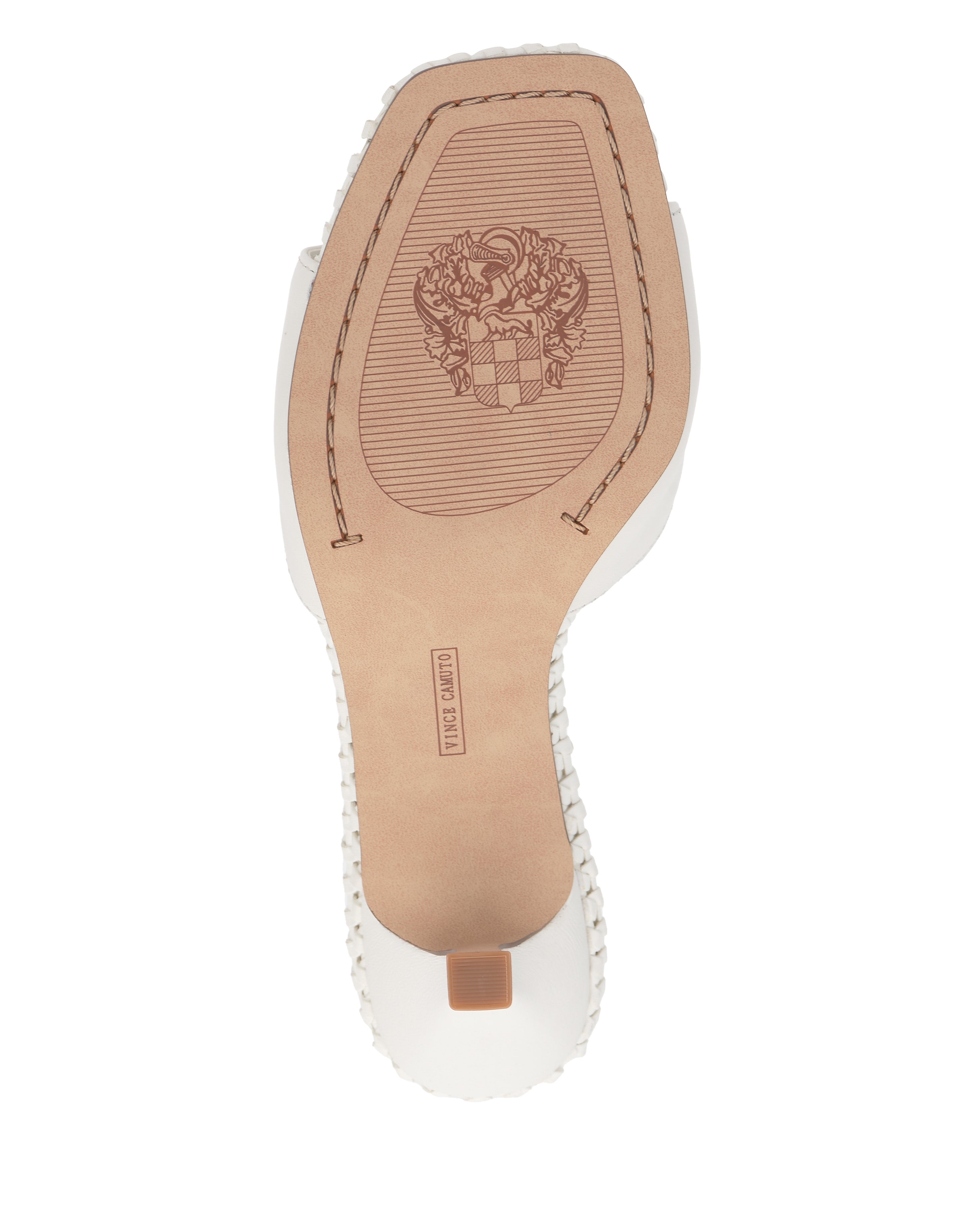 The image shows the sole of the Emmla Mule by Vince Camuto—a white, modern sandal with a square toe, visible edge stitching, a detailed floral emblem near the arch, and a small rectangular heel.