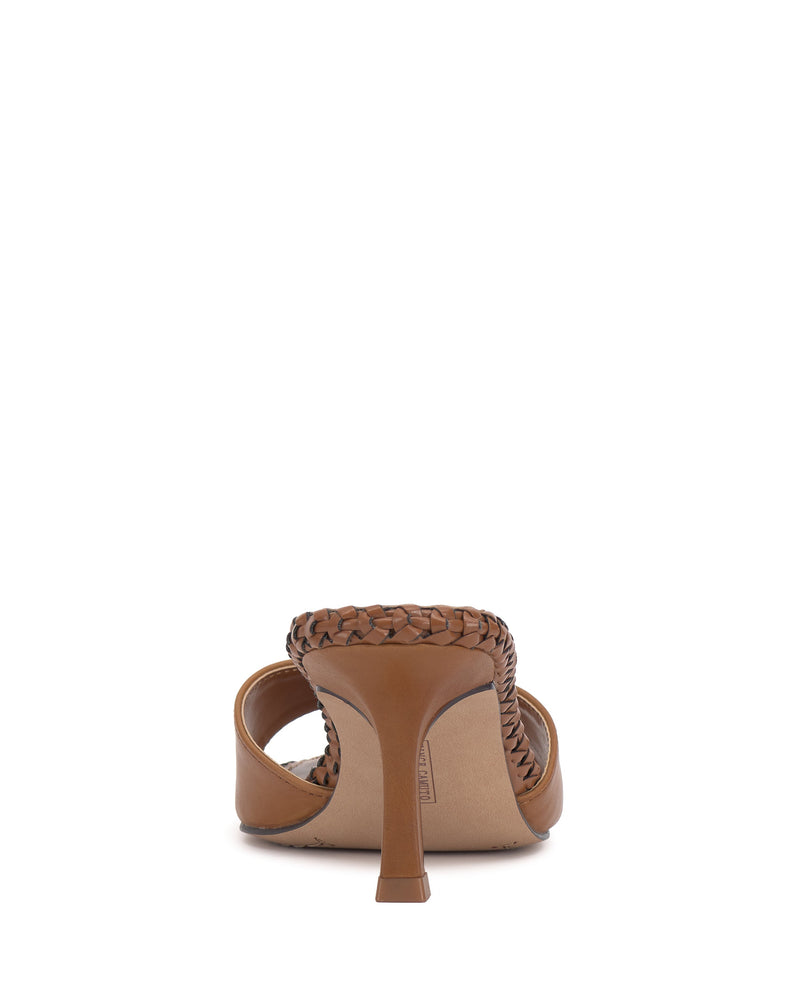 Rear view of the Vince Camuto Emmla Mule, a brown high-heeled shoe with a woven strap and open back, showcasing modern elegance against a plain white background.