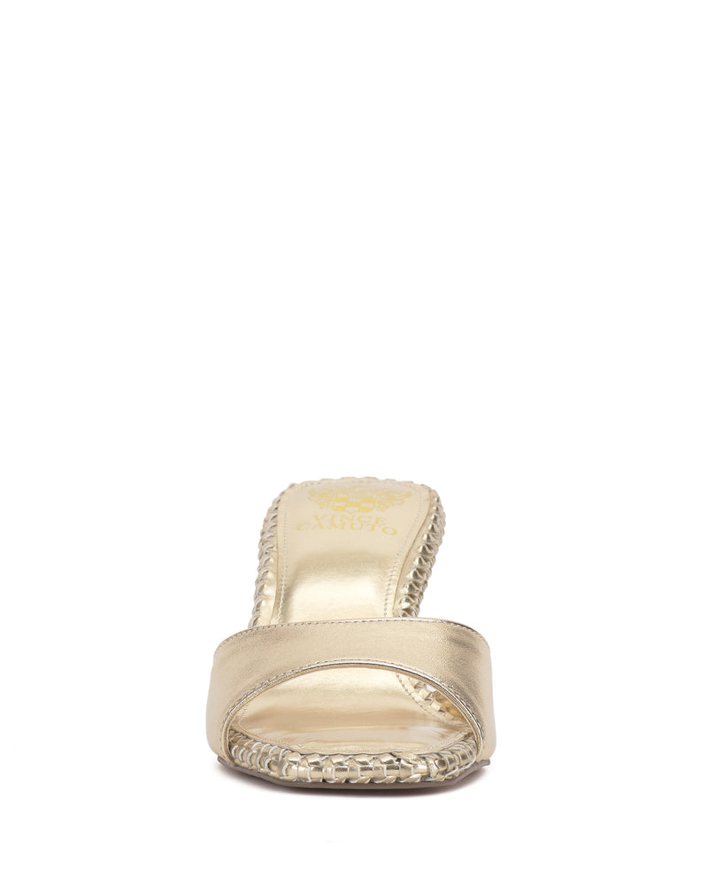 Front view of the Emmla Mule by Vince Camuto—a gold open-toe slide with a wide strap and textured sole detailing. This modern sandal features a shiny finish and flat heel for an elegant look.