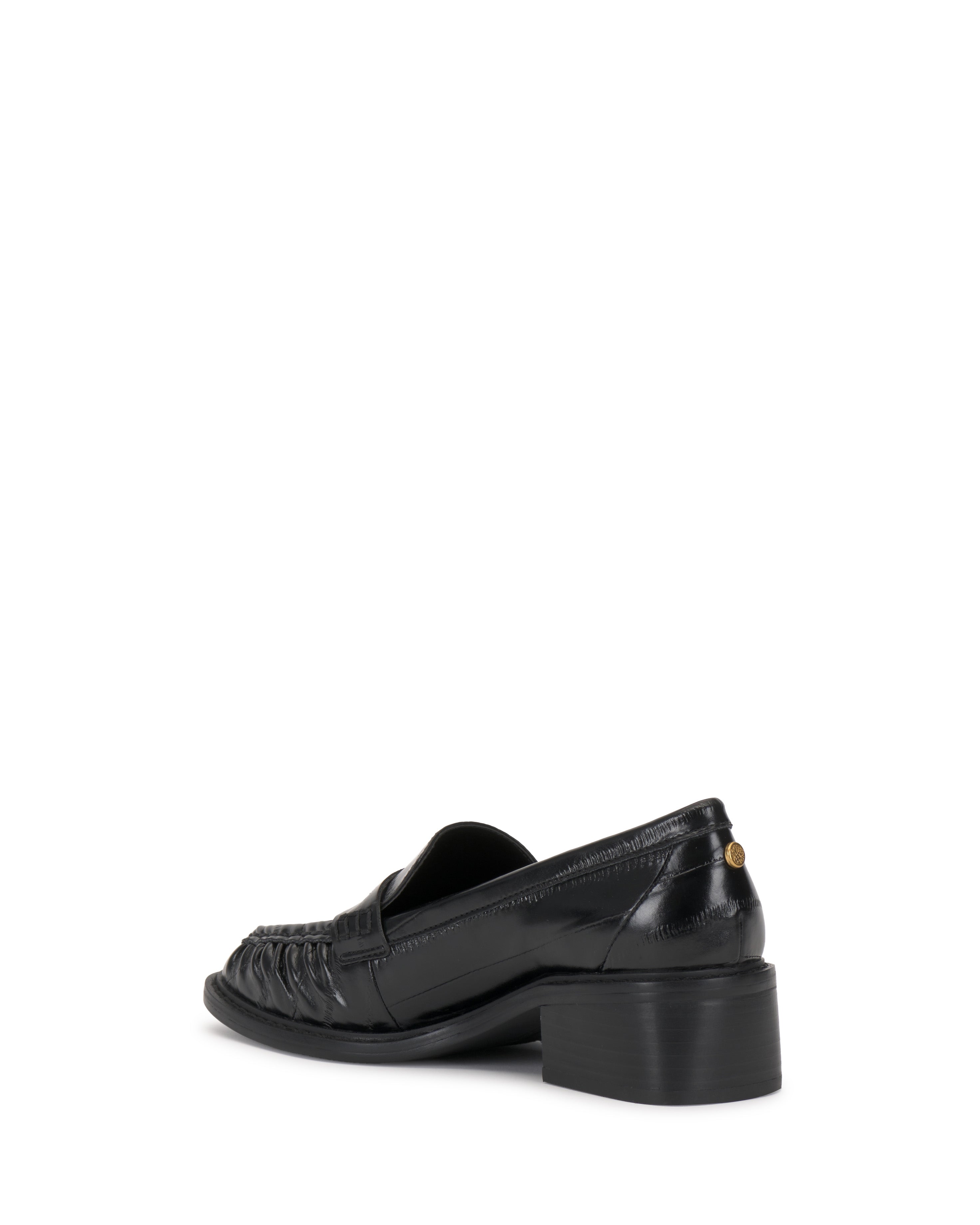 The Vince Camuto Eshnie Block Heel Loafer showcases black leather, a low block heel, and a woven front design, seen from a rear side angle on a white background.