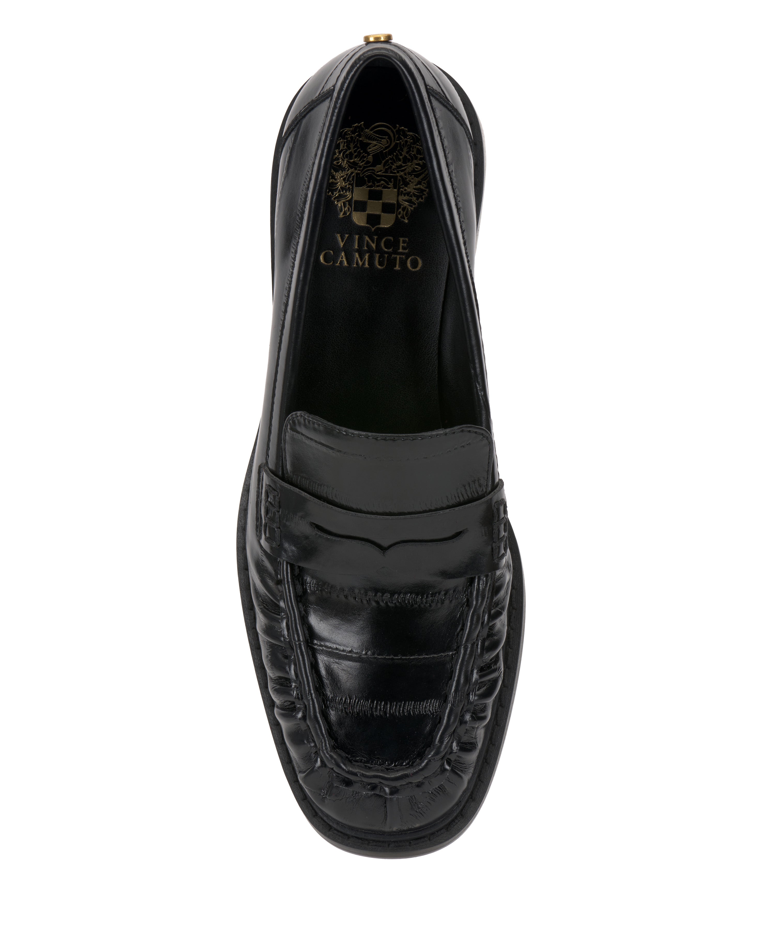 The Eshnie Block Heel Loafer by Vince Camuto features a stitched moc toe, smooth black leather upper, subtle block heel, and a gold Vince Camuto logo on the insole.