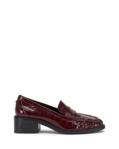 The Eshnie Block Heel Loafer by Vince Camuto is shown on a white background with burgundy crocodile-embossed leather, a low block heel, and classic penny loafer accents.