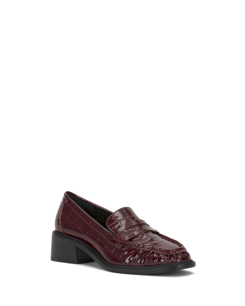 The Vince Camuto Eshnie Block Heel Loafer showcases dark red, crocodile-embossed leather and a chunky block heel, set against a plain white background.