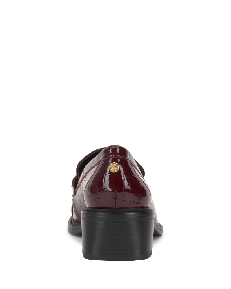 Back view of the Vince Camuto Eshnie Block Heel Loafer in shiny burgundy, showcasing a low black heel and a small gold emblem on the upper heel.