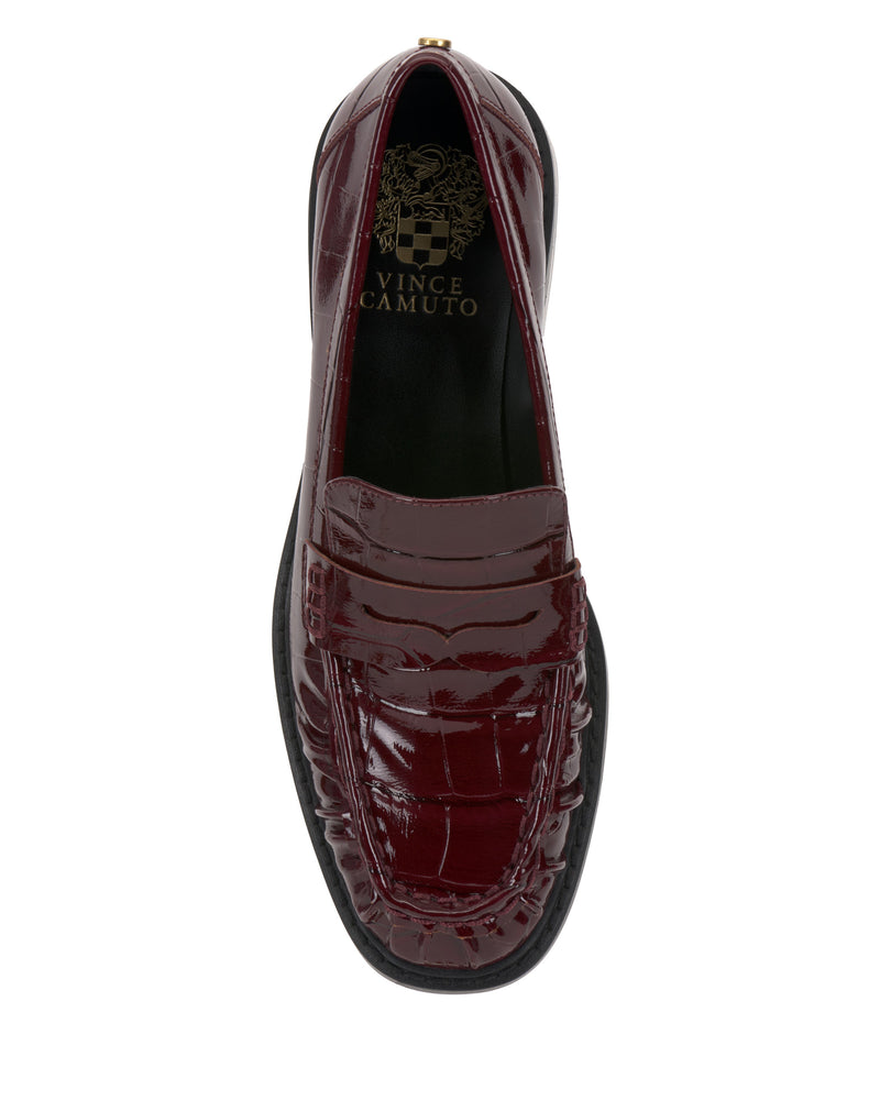 Top view of the Vince Camuto Eshnie Block Heel Loafer in burgundy crocodile-embossed leather, featuring a penny slot, black sole, subtle block heel, and Vince Camuto branding on the insole.