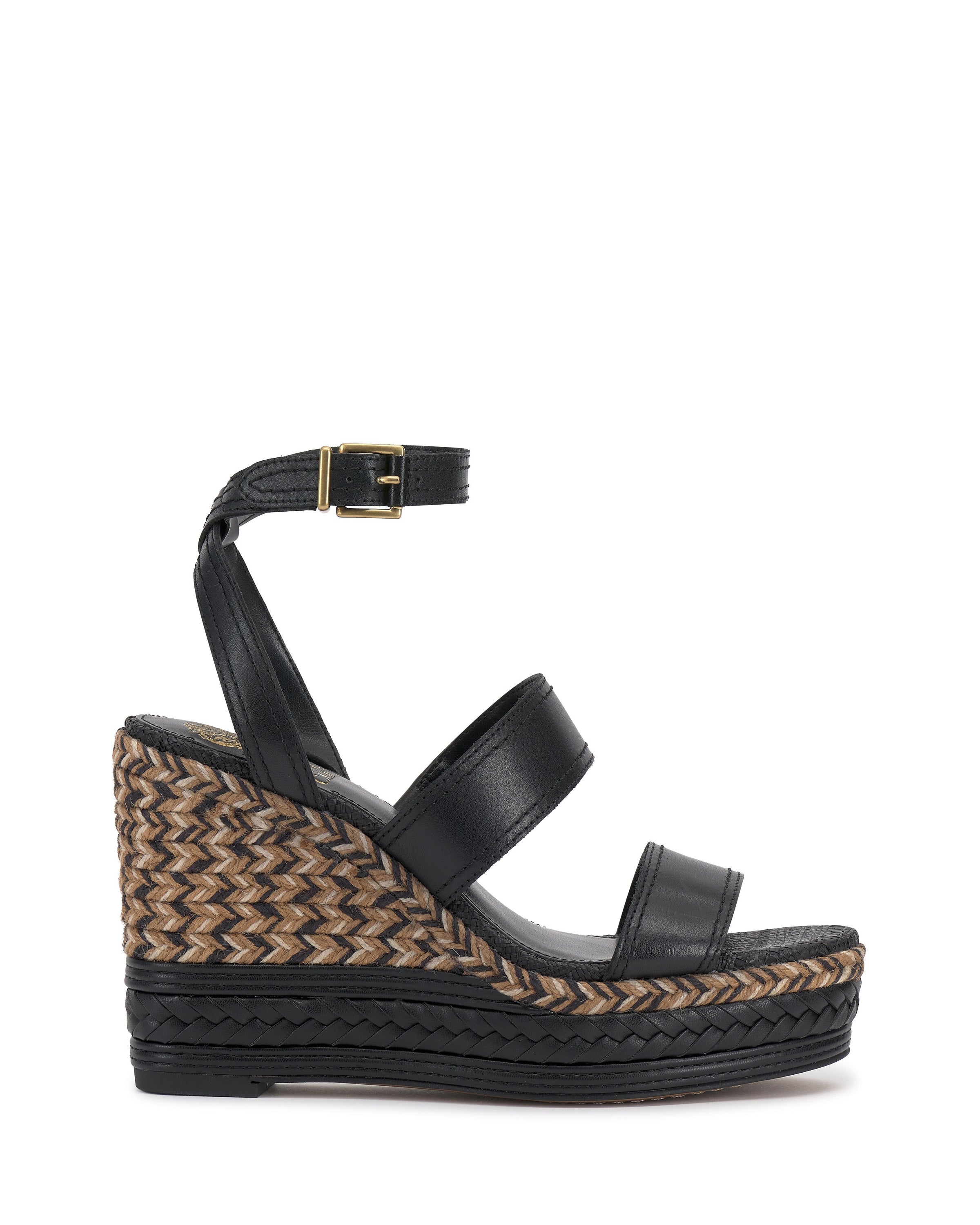 The Esmia Espadrille Wedge Sandal by Vince Camuto features a black ankle strap with buckle, twin front straps, and a chevron-patterned brown and beige braided wedge. The sole is detailed with a black zigzag near the bottom.