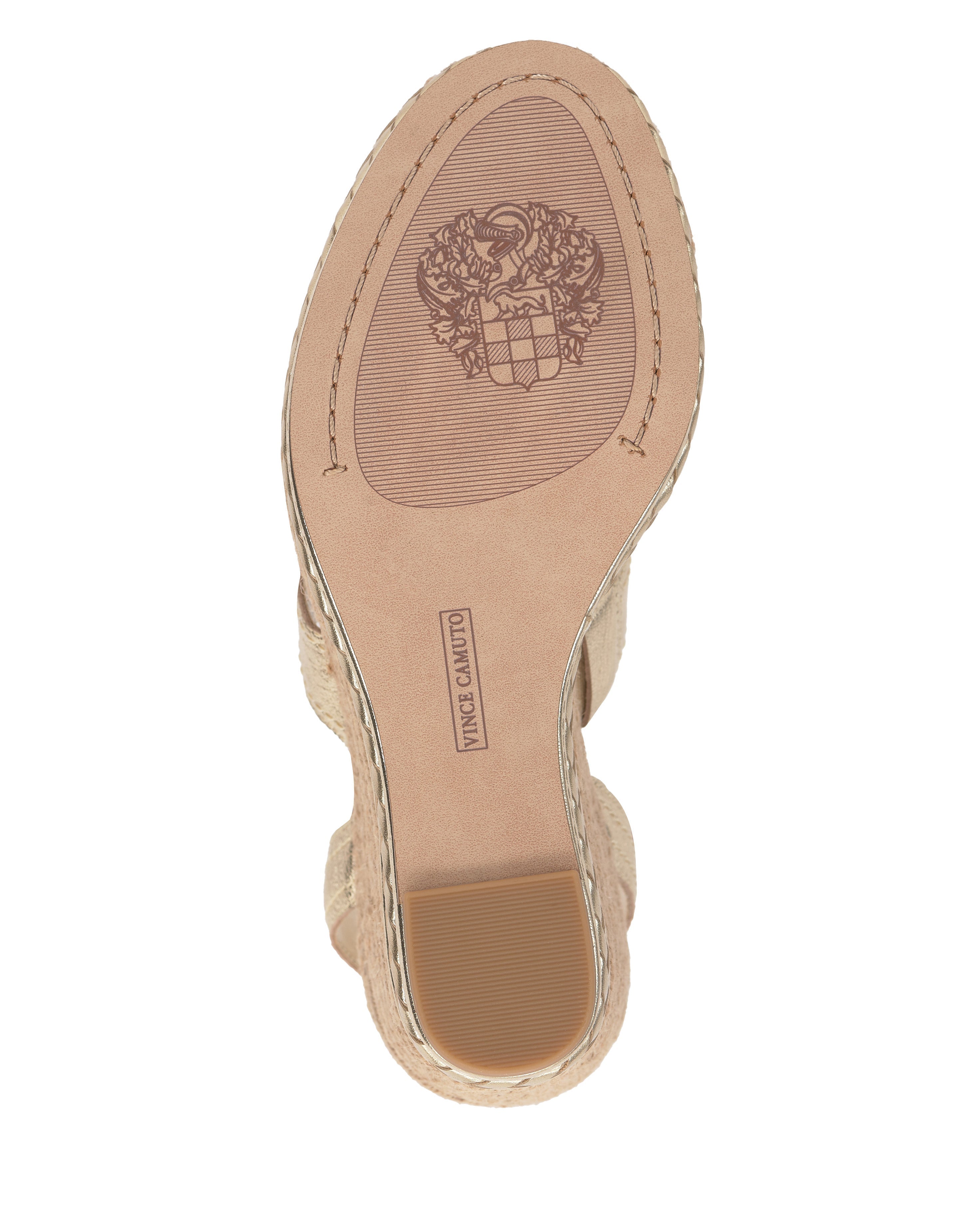 The image shows the sole of the beige Esmia Espadrille Wedge Sandal by Vince Camuto, featuring a crest design, "Vince Camuto" stamped in the center, edge stitching, a textured heel patch, and a braided espadrille platform heel.