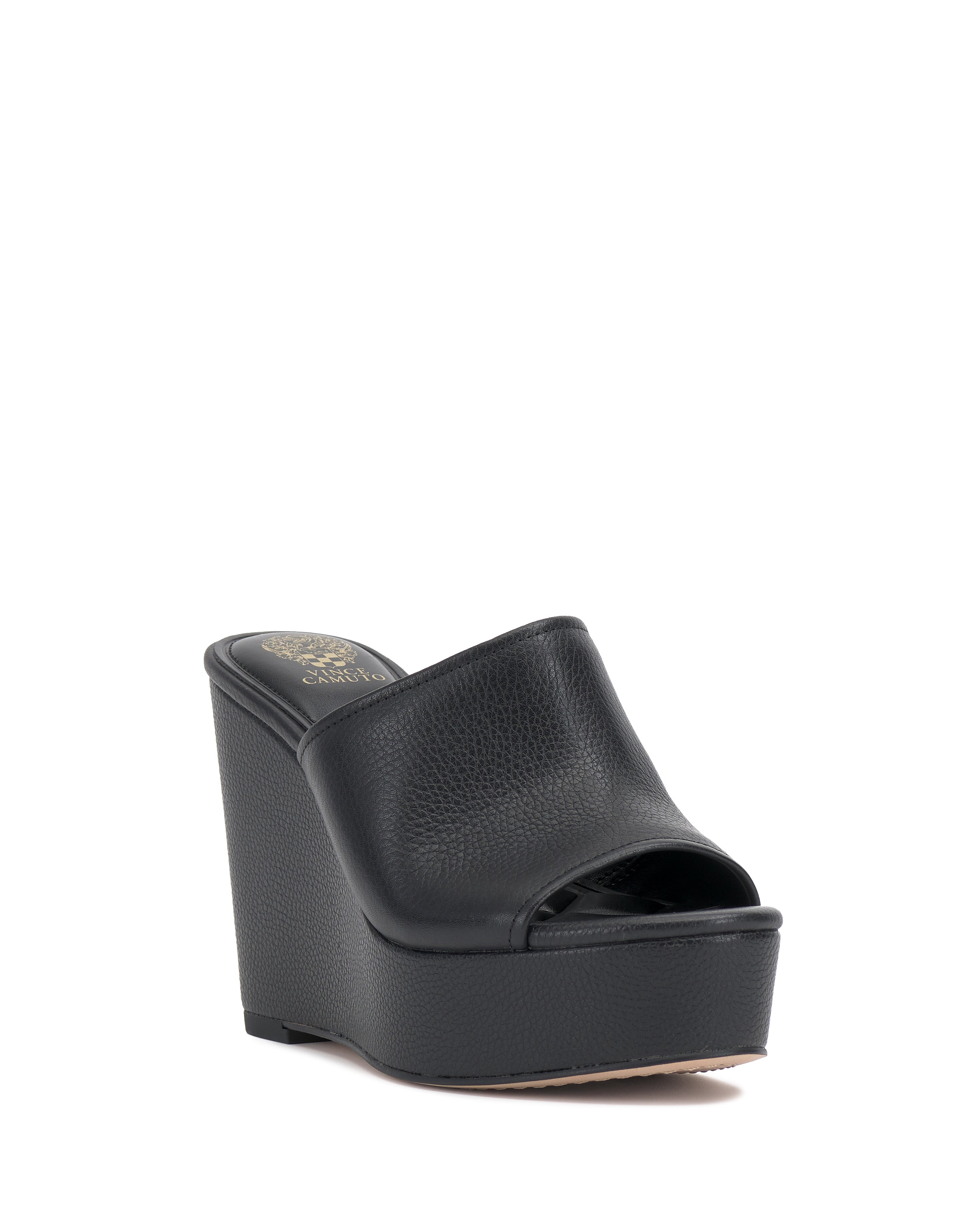 The Vince Camuto Etta Wedge Sandal is a black Y2K-inspired platform with a thick sole, open toe, and wide textured leather strap over the foot, shown against a white background.