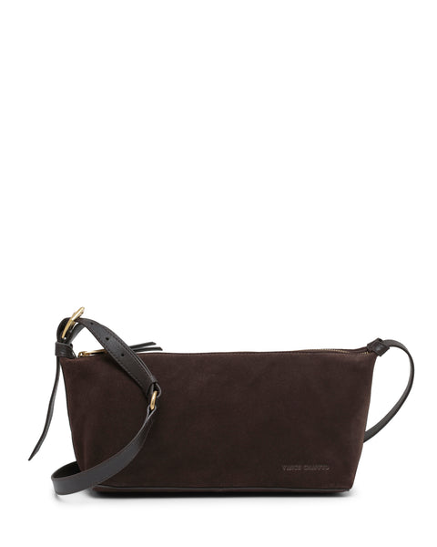 The Faey Shoulder Bag by Vince Camuto is crafted from dark brown suede, featuring a black adjustable leather strap and gold hardware, and is displayed against a white background.