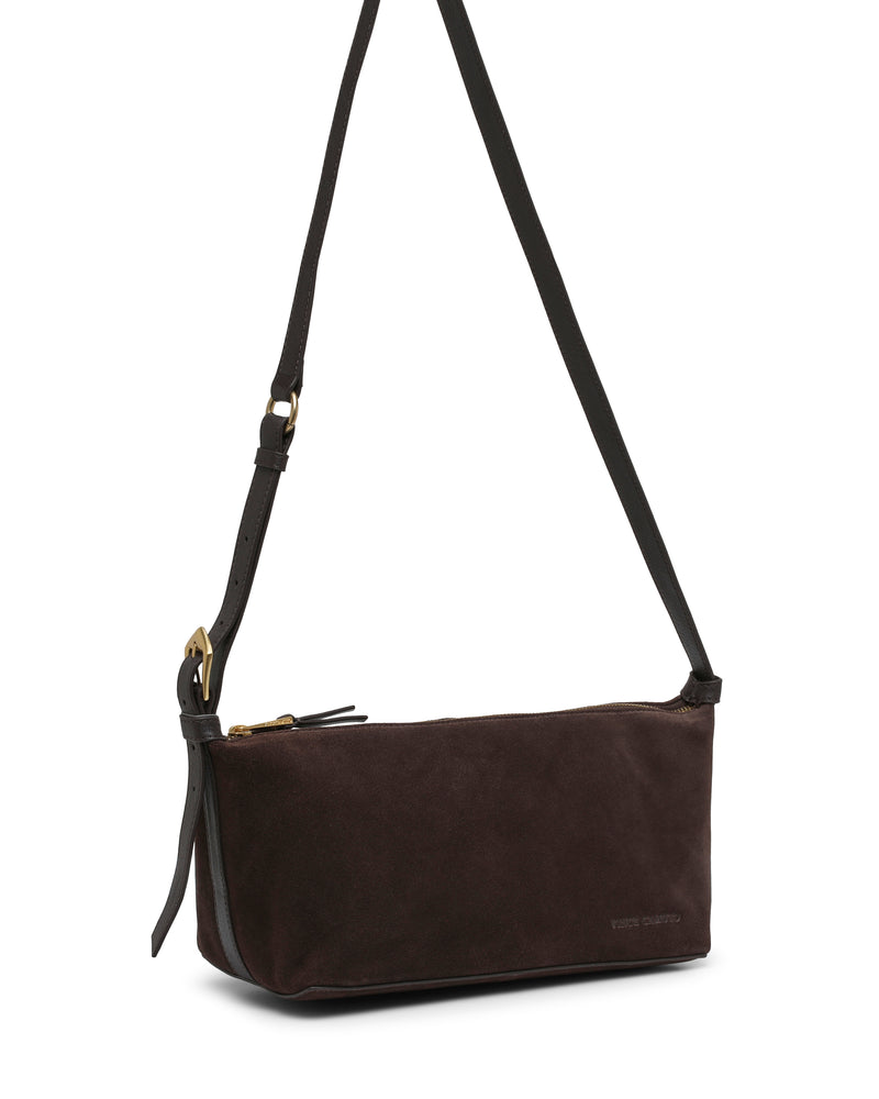 The Faey Shoulder Bag by Vince Camuto is a dark brown suede shoulder bag featuring a long adjustable black strap, gold buckle, and zipper closure, photographed against a white background.