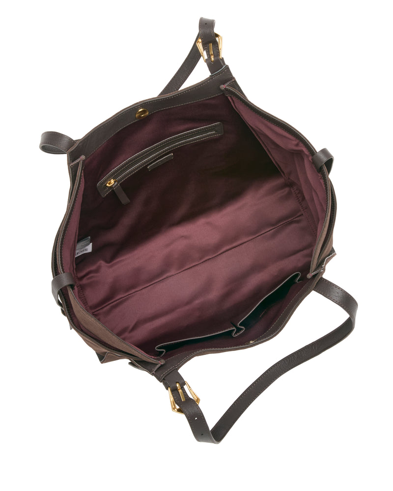 The Faey Tote Bag by Vince Camuto is an open brown leather handbag with gold hardware, shown from above. Its interior is lined with dark burgundy fabric and includes a zipper pocket and two open pockets. The bag features two shoulder straps.