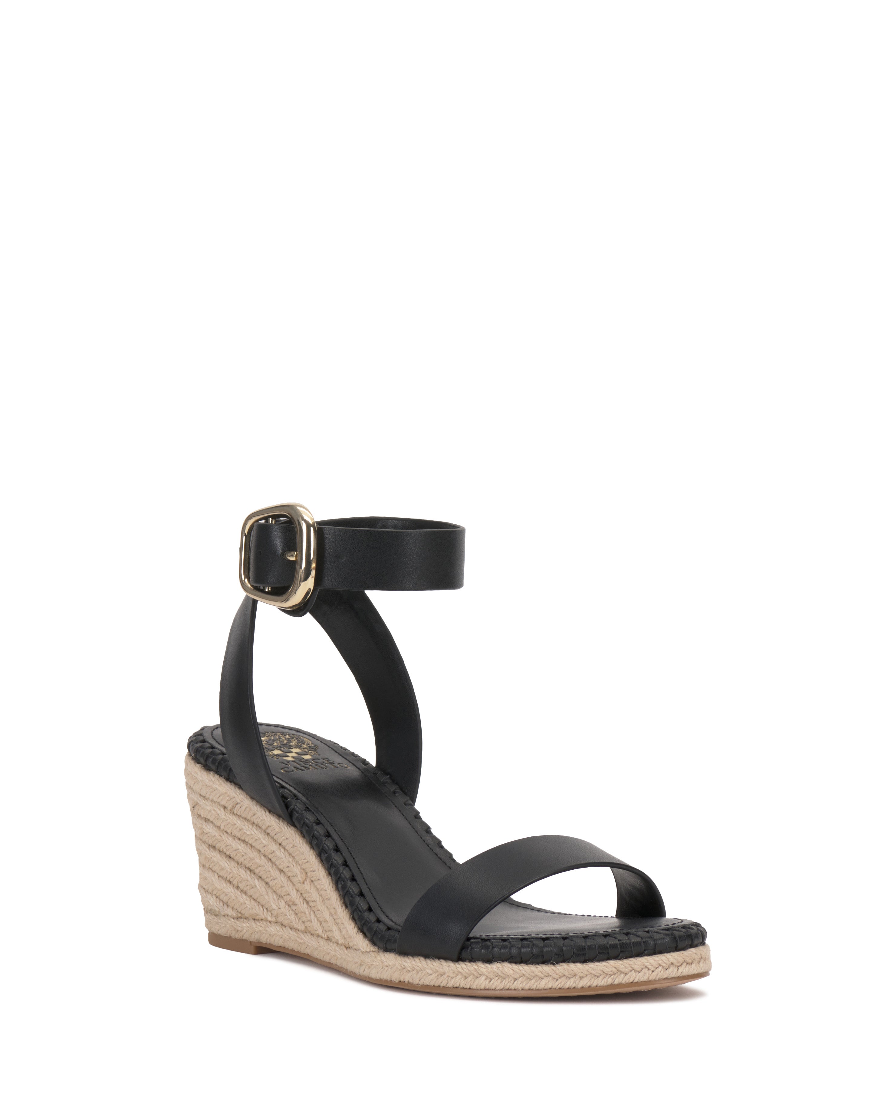 The Vince Camuto Fainel Espadrille Wedge Sandal features a black ankle strap, gold buckle, and woven sole, shown on a white background for a chic summer look.