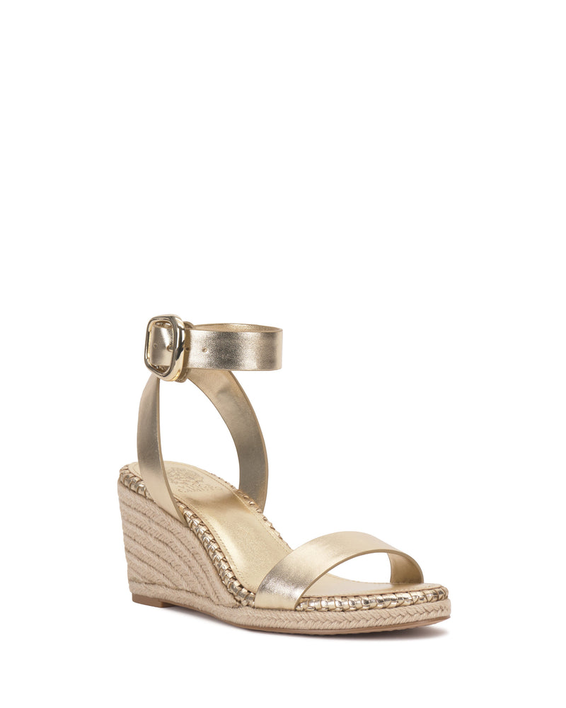 The Vince Camuto Fainel Espadrille Wedge Sandal features a gold finish, open toe, ankle strap, and bold buckle closure, perfect for summer. Displayed against a white background.