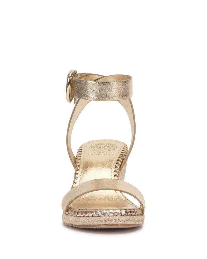 Front view of the Vince Camuto Fainel Espadrille Wedge Sandal in gold, featuring a braided espadrille wedge heel, open toe, a single front strap, and an ankle strap with a bold buckle closure.