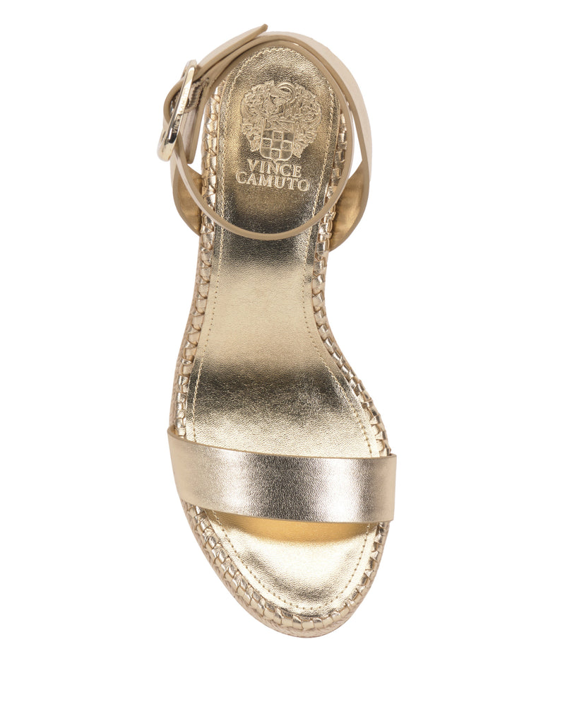 The Vince Camuto Fainel Espadrille Wedge Sandal is a metallic gold summer shoe with a single front strap, bold ankle buckle, espadrille-style wedge heel, and branded insole.