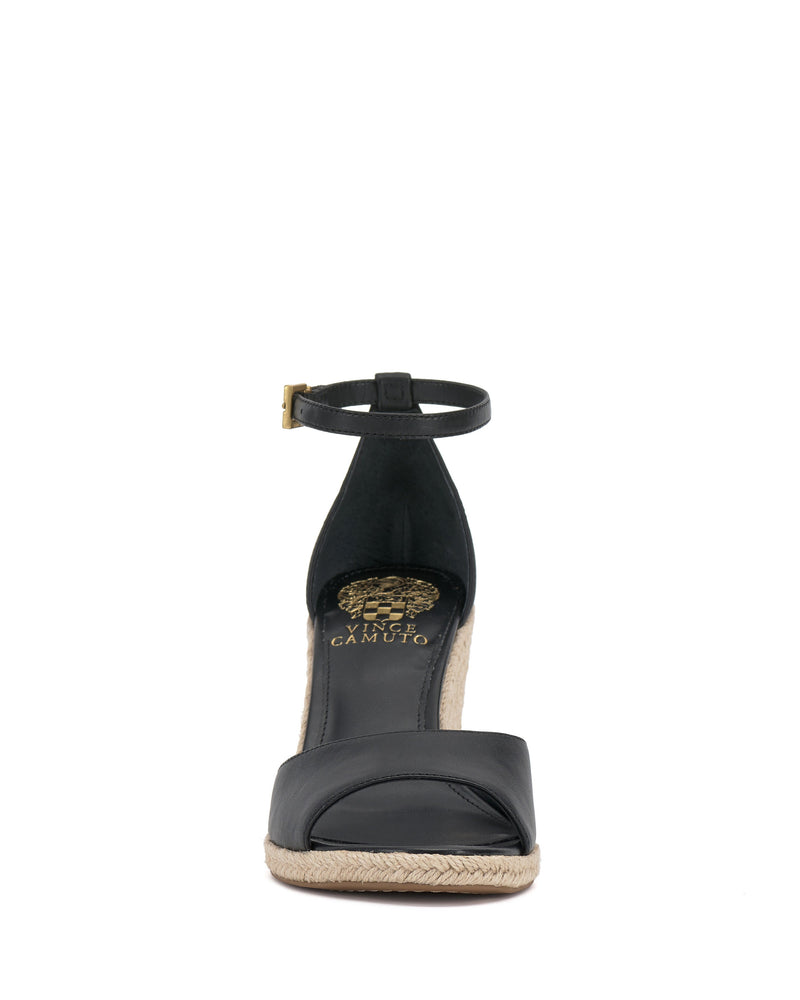 Front view of the Vince Camuto Felyn Espadrille Wedge Sandal, a black open-toe style with an ankle strap, woven espadrille sole, and gold logo on the footbed.