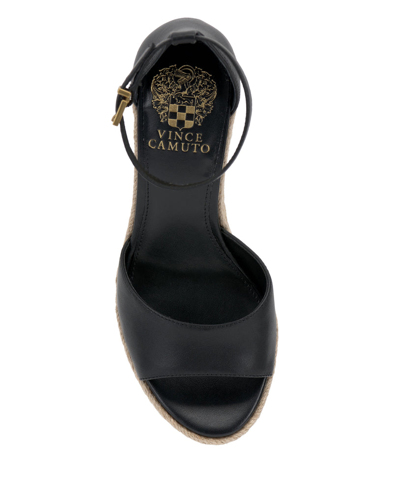 The Vince Camuto Felyn Espadrille Wedge Sandal in black features an open toe, ankle strap, gold insole logo, and a woven espadrille trim on the sole, shown from above.