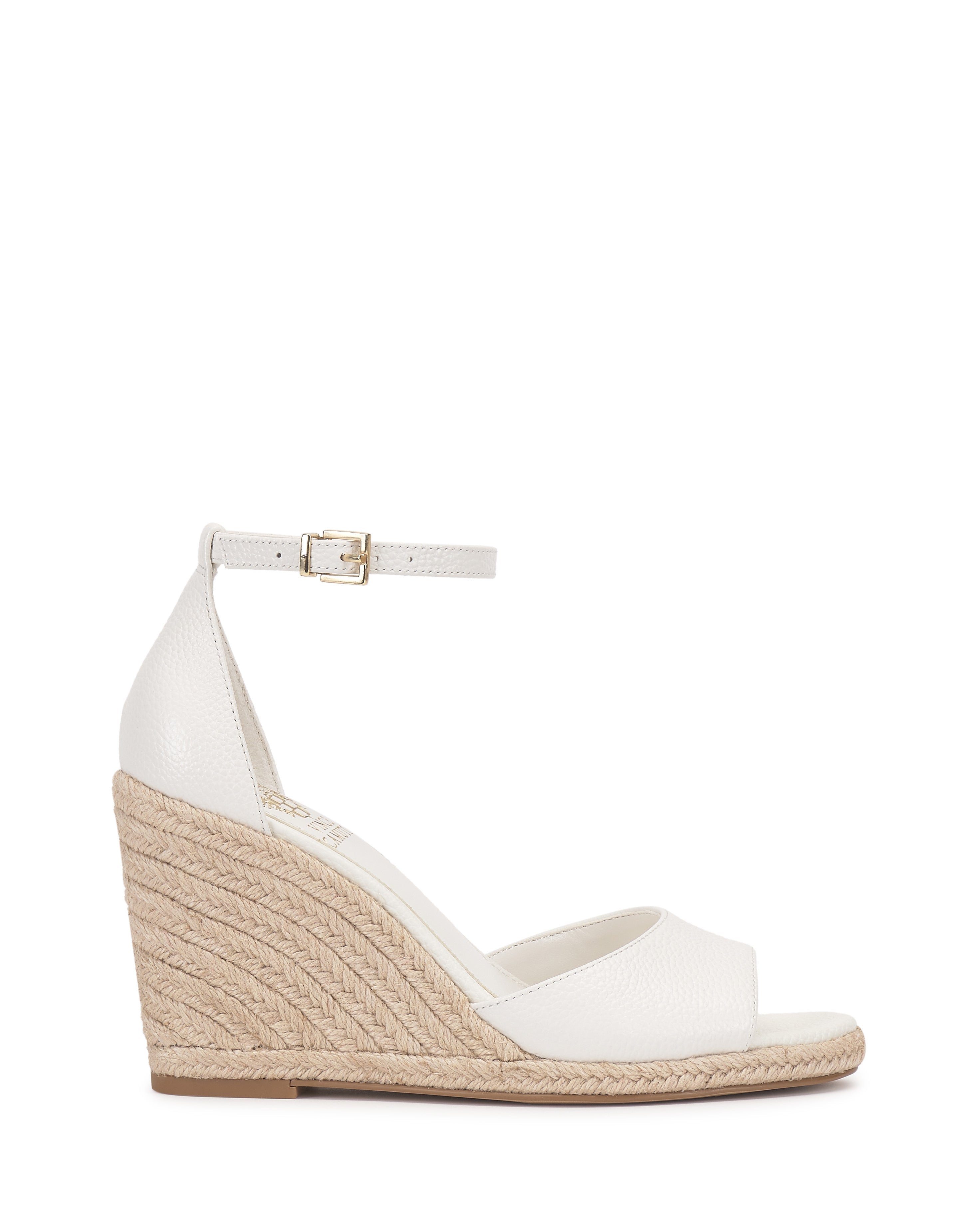 The Vince Camuto Felyn Espadrille Wedge Sandal is a white open-toe shoe with an ankle strap and buckle, plus a textured espadrille heel for a chic, summery style.