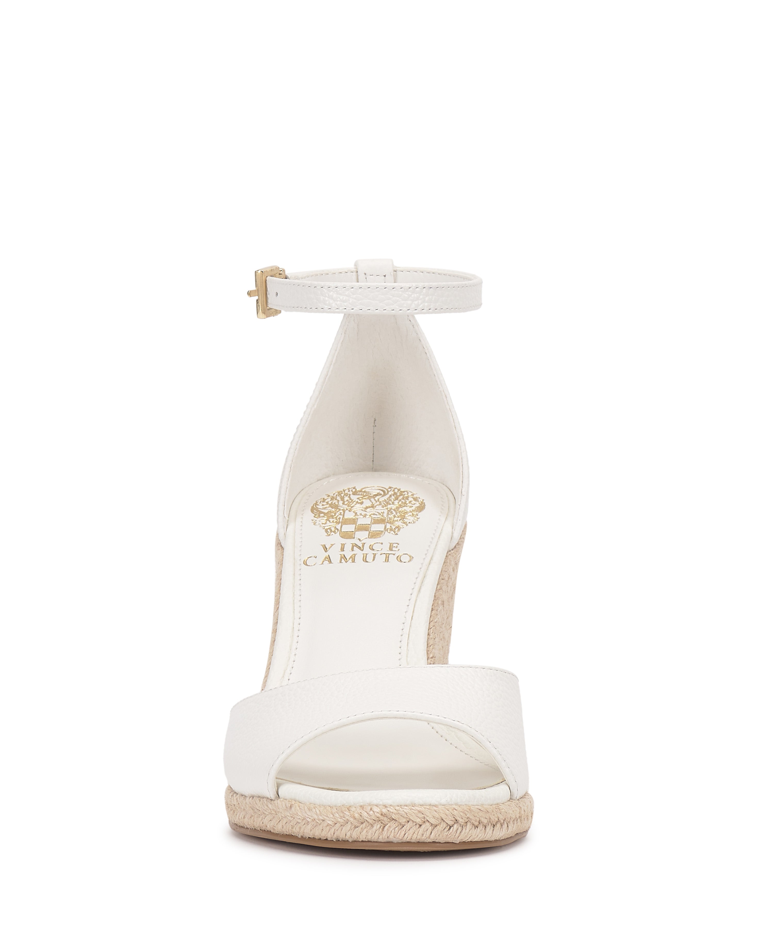 Front view of the Felyn Espadrille Wedge Sandal by Vince Camuto, a white open-toe style with ankle strap and buckle, espadrille heel, textured sole, and gold Vince Camuto branding on the insole.