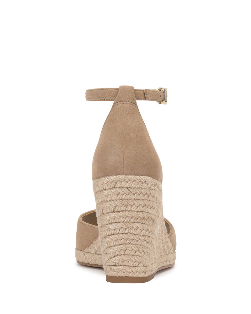 The Vince Camuto Felyn Espadrille Wedge Sandal is shown from the back, highlighting its braided rope espadrille heel, closed heel counter, and ankle strap with small buckle.