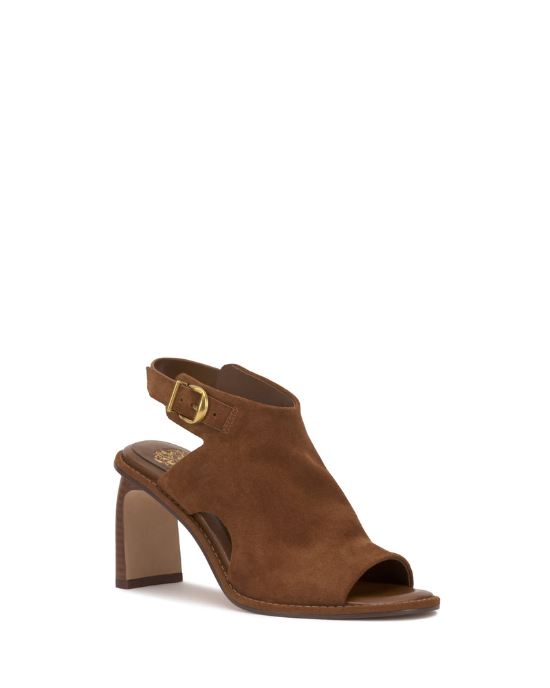 The Fezisha Sandal by Vince Camuto is a brown suede heeled sandal with an open toe, thick heel, open back, and an ankle strap with a gold buckle.