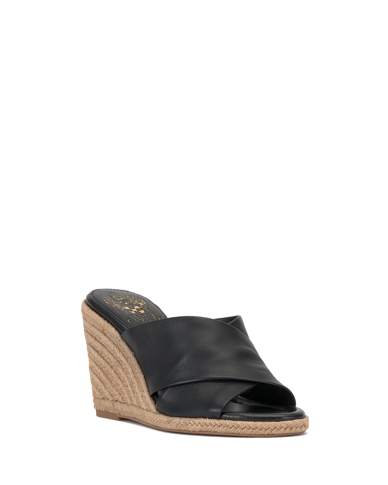 The Vince Camuto Fisella Espadrille Wedge Sandal is a black, open-toe slip-on with a crisscross leather upper and espadrille platform heel, shown angled on a white background.